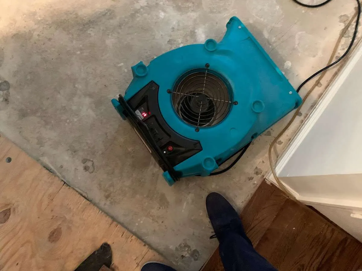 Air mover drying subfloor during Commercial Water Damage Restoration in Kingfisher